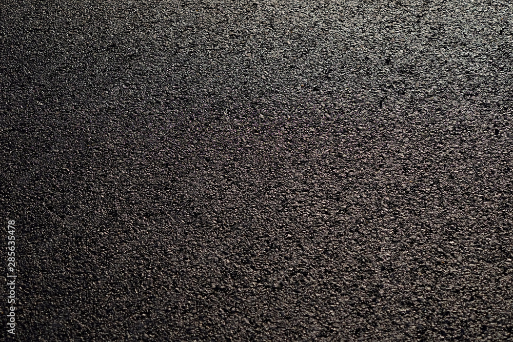 Fototapeta premium wet asphalt road with sunny texture