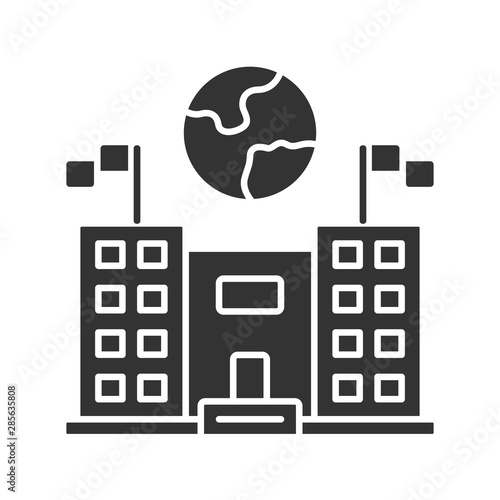 Immigration center glyph icon. Embassy and consulate building. Administrative governmental structure. Earth globe over public building. Silhouette symbol. Negative space. Vector isolated illustration