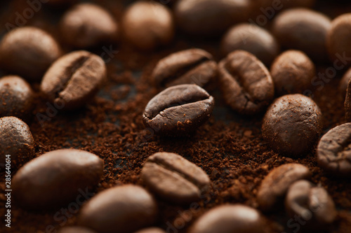 Aromatic brown coffee beans mixed with ground coffee