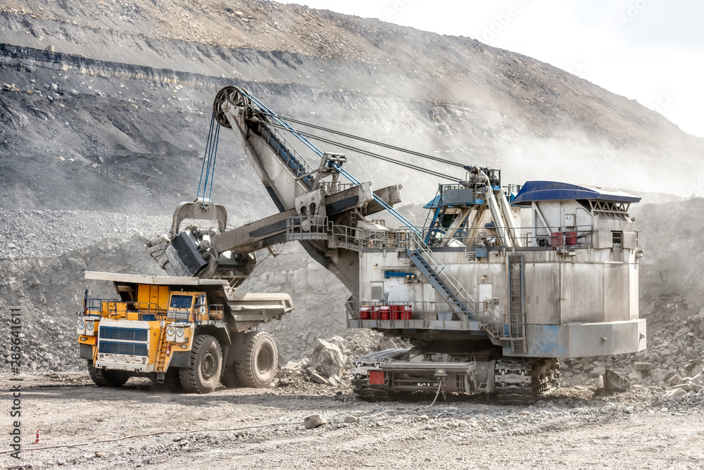Ore loading with a powerful excavator. Loading a large mining truck.