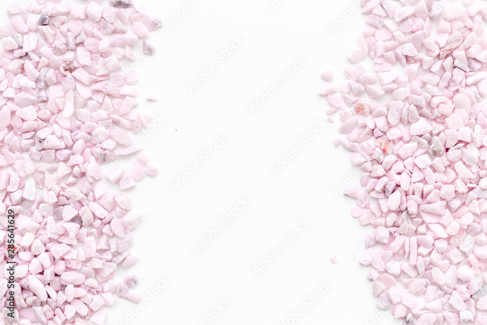 pink stones frame on white background top view