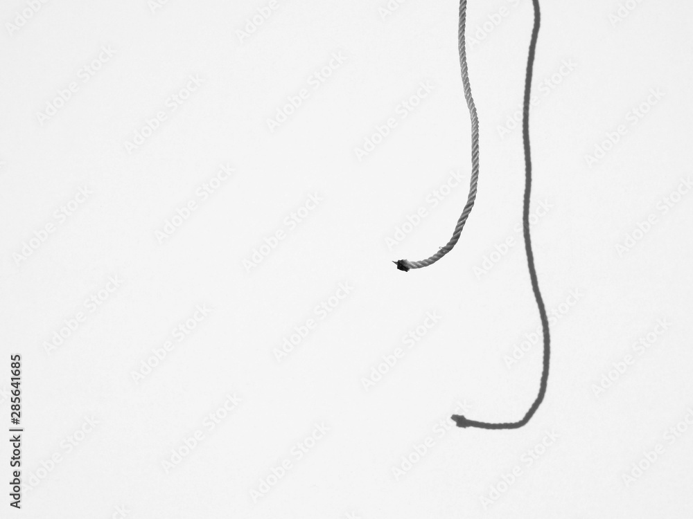 rope with shadow on the wall minimalism style, black and white rope with shadow on the wall minimalism style, black and white
