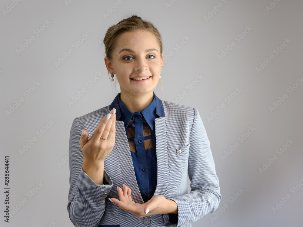 Studio photo a waist-high portrait of a pretty young woman girl in a business suit on a white background. He stands right in front of the camera, explains, with emotion. Studio photo a waist-high portrait of a pretty young woman girl in a business suit on a white background. He stands right in front of the camera, explains, with emotion.