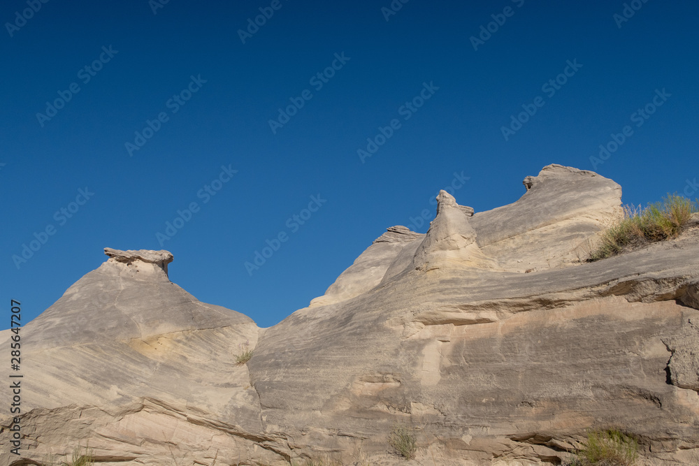 Low angle landscape of grey rock formations at the Toadstools trail in Grand Staircase Escalante National Monument in Utah