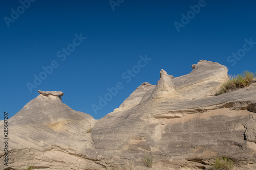 Low angle landscape of grey rock formations at the Toadstools trail in Grand Staircase Escalante National Monument in Utah