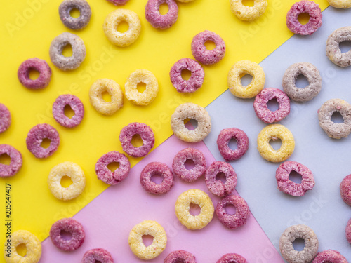 Fruit cereal loops on a colorful background