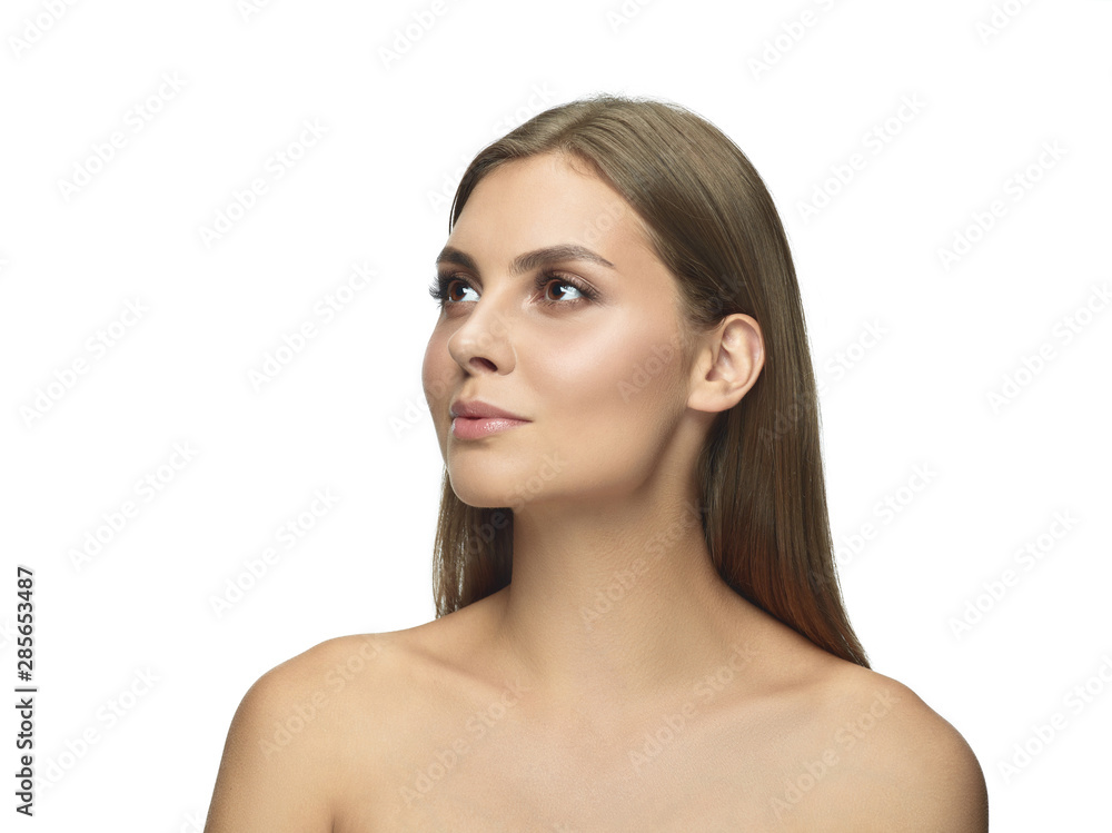 Portrait of beautiful young woman isolated on white studio background. Caucasian female model looking at side and posing. Concept of women's health and beauty, self-care, body and skin care. Portrait of beautiful young woman isolated on white studio background. Caucasian female model looking at side and posing. Concept of women's health and beauty, self-care, body and skin care.