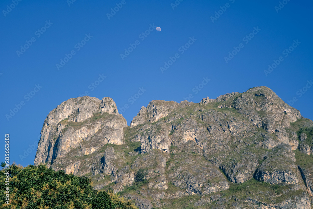 High mountain with a moon on it in the morning