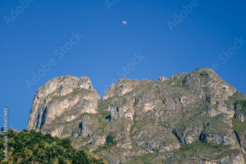 High mountain with a moon on it in the morning