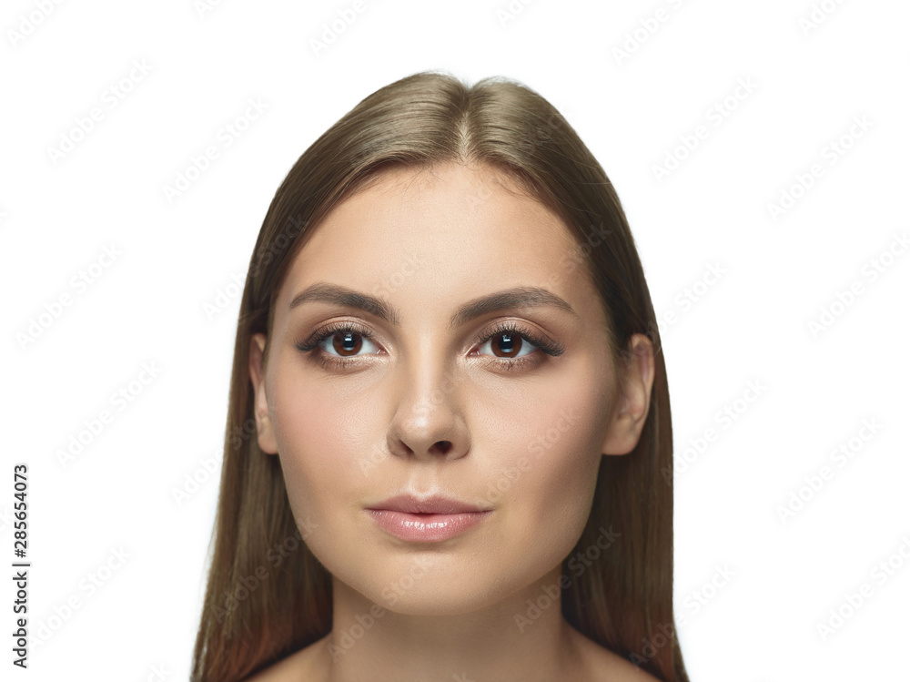 Portrait of beautiful young woman isolated on white studio background. Caucasian healthy female model looking at camera and posing. Concept of women's health and beauty, self-care, body and skin care. Portrait of beautiful young woman isolated on white studio background. Caucasian healthy female model looking at camera and posing. Concept of women's health and beauty, self-care, body and skin care.