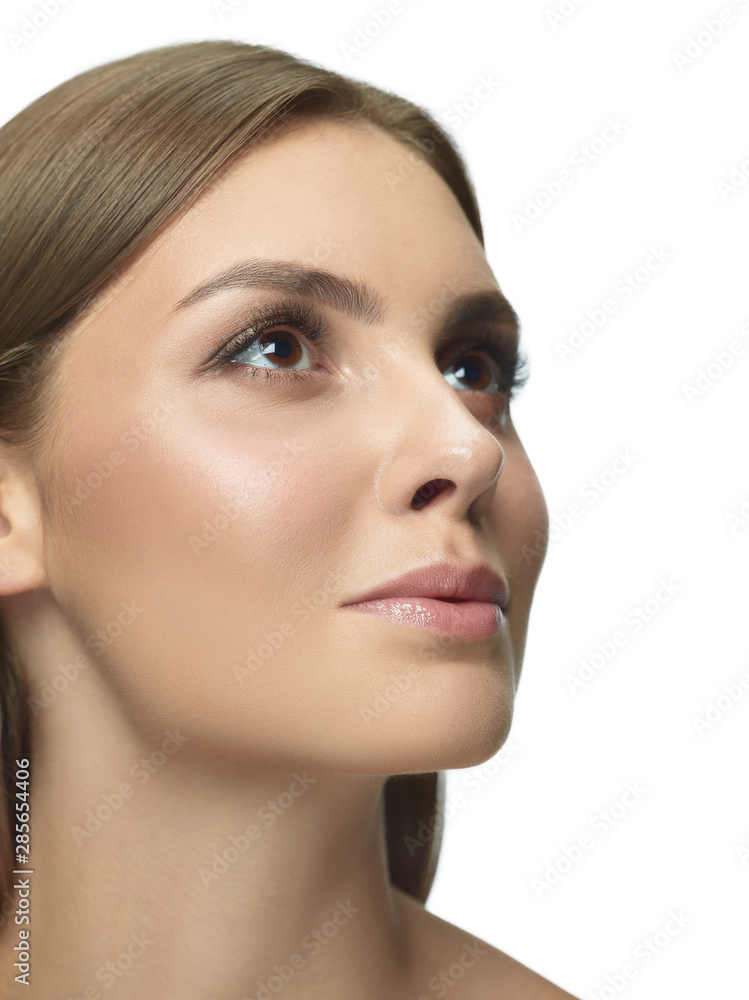 Portrait of beautiful young woman isolated on white studio background. Caucasian female model looking at side and posing. Concept of women's health and beauty, self-care, body and skin care. Portrait of beautiful young woman isolated on white studio background. Caucasian female model looking at side and posing. Concept of women's health and beauty, self-care, body and skin care.