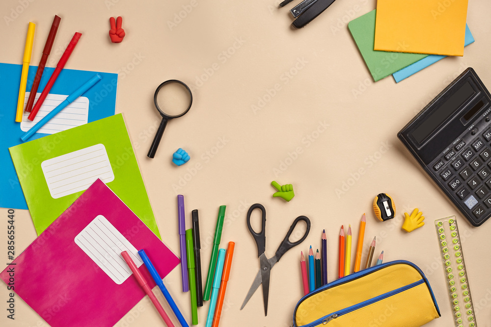 Flat lay photo of workspace desk with school accessories or office supplies on pink background. Flat lay photo of workspace desk with school accessories or office supplies on pink background.