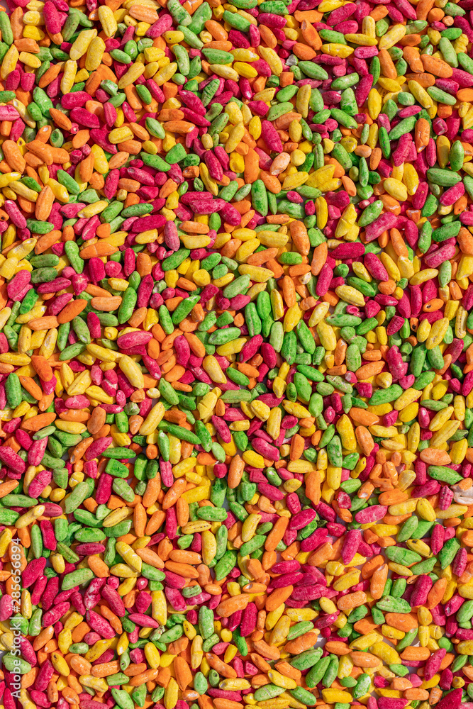 Bright multi-colored background of painted foam rice