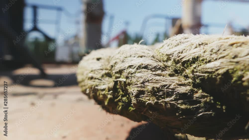 Close-up nautical knot rope tied around stake on boat or ship, boat mooring rope. Marine rope on the ship. The ship leaves the port. Lighthouse. Mooring rope. Ship in the harbor. Close-up nautical knot rope tied around stake on boat or ship, boat mooring rope. Marine rope on the ship. The ship leaves the port. Lighthouse. Mooring rope. Ship in the harbor.