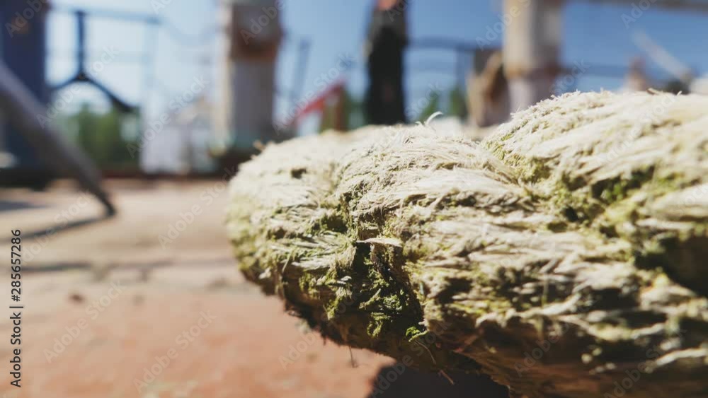 Close-up nautical knot rope tied around stake on boat or ship, boat mooring rope. Marine rope on the ship. The ship leaves the port. Lighthouse. Mooring rope. Ship in the harbor. Close-up nautical knot rope tied around stake on boat or ship, boat mooring rope. Marine rope on the ship. The ship leaves the port. Lighthouse. Mooring rope. Ship in the harbor.