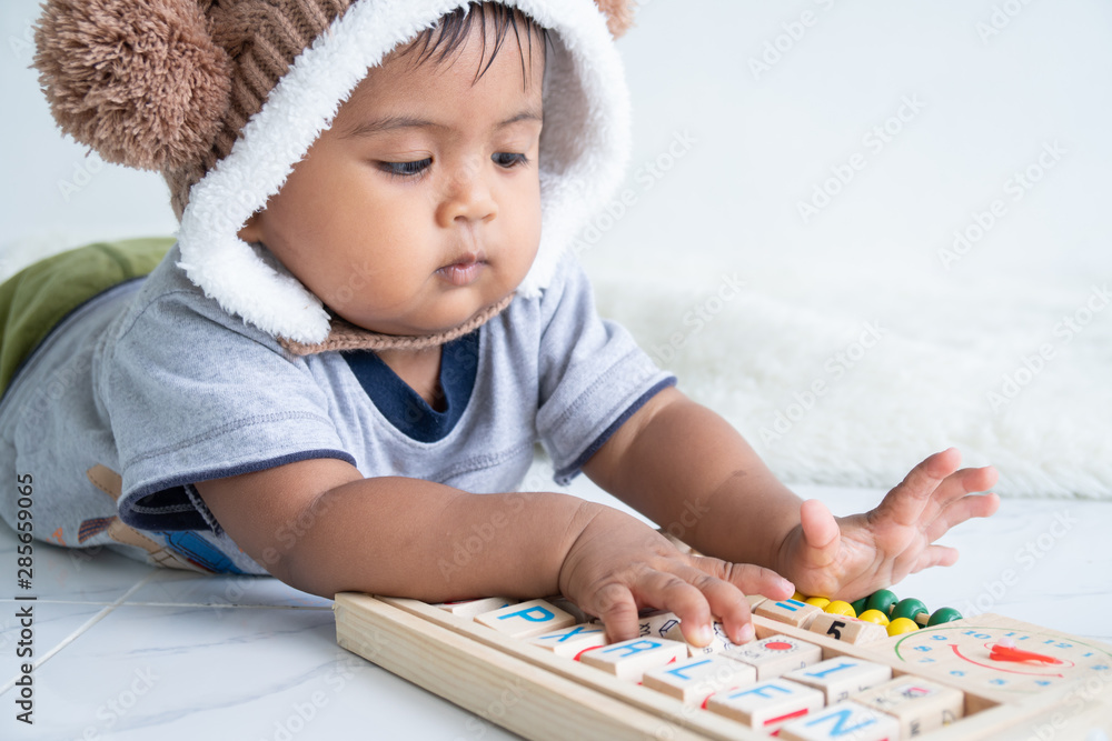 cute little asin baby boy playing with wooden toy cute little asin baby boy playing with wooden toy