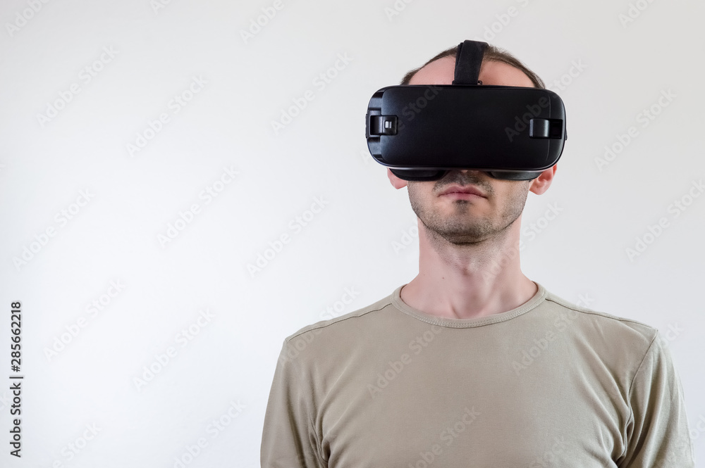 Man exploring modern technology virtual reality with head mounted display on white background Man exploring modern technology virtual reality with head mounted display on white background