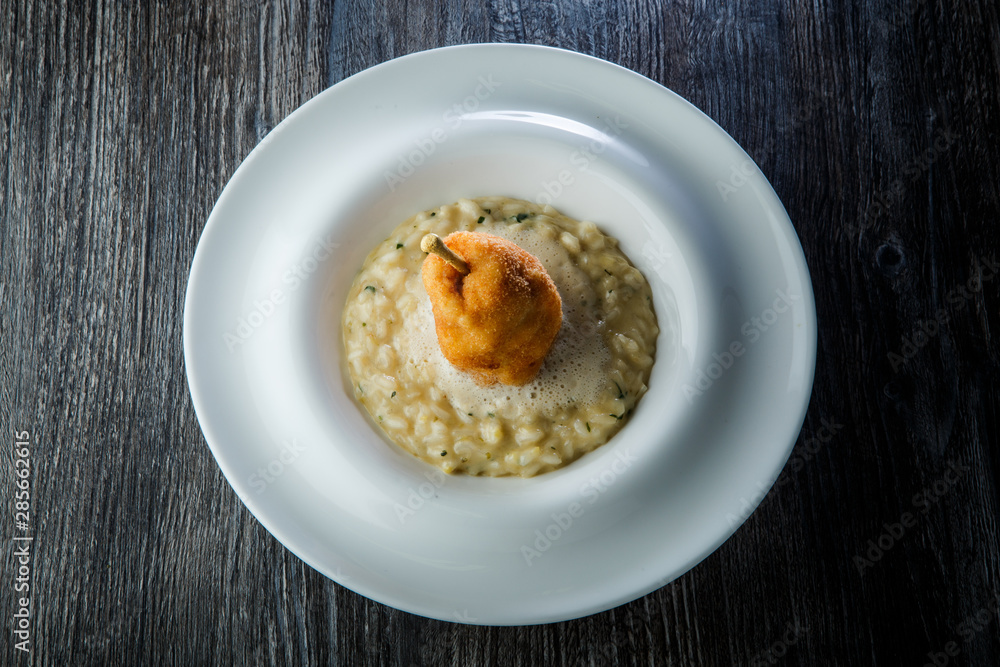 top view on boiled barley porridge finely decorated with breaded whole pear top view on boiled barley porridge finely decorated with breaded whole pear
