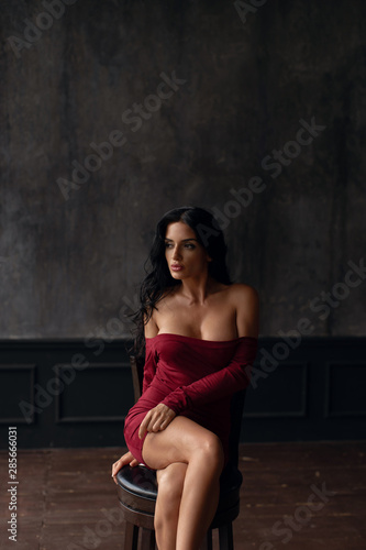 Young sexy brunette in a red dress © fotoplaton
