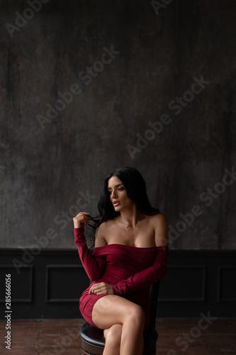 Young sexy brunette in a red dress © fotoplaton