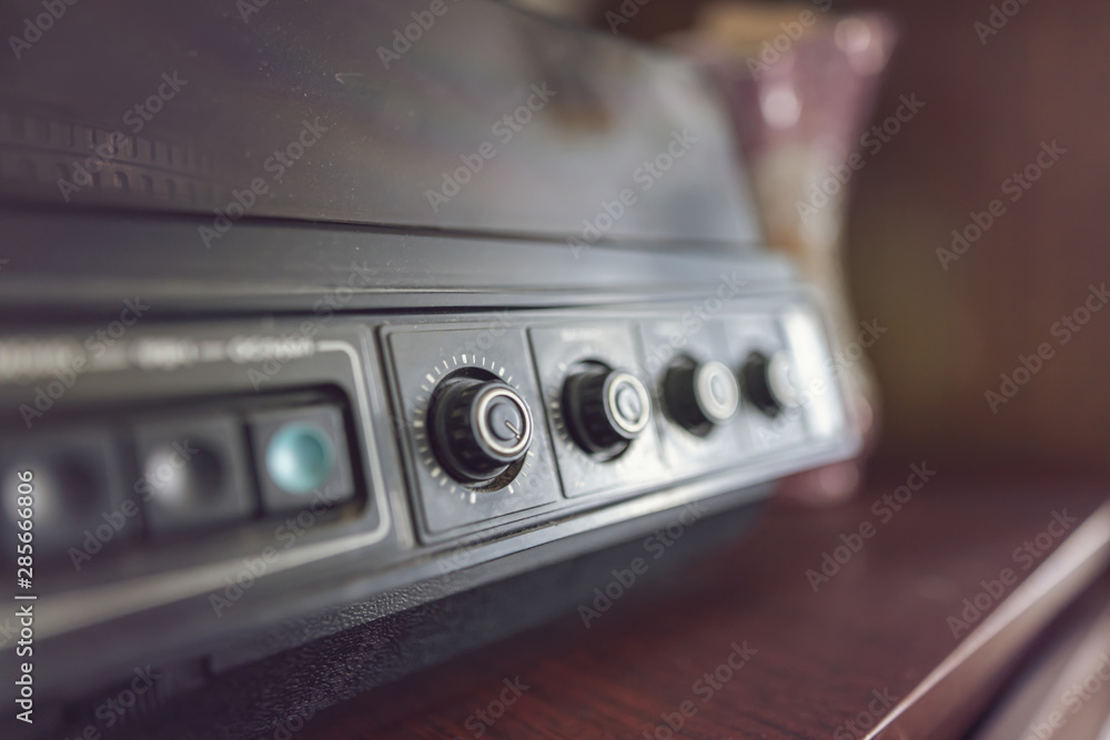 Fototapeta premium An old vinyl record player with wooden cases