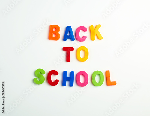 inscription back to school from multi-colored plastic letters