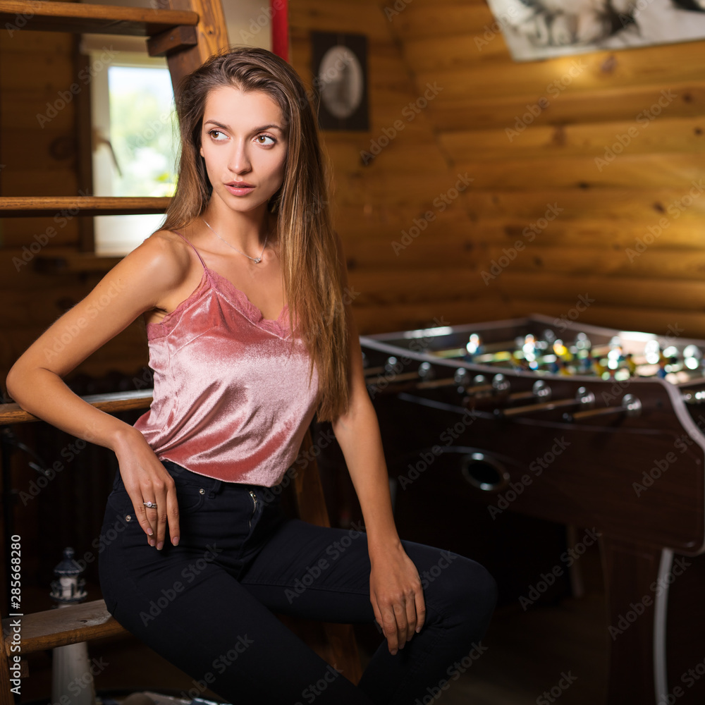 Young beauty woman in wooden house interior. Young beauty woman in wooden house interior.