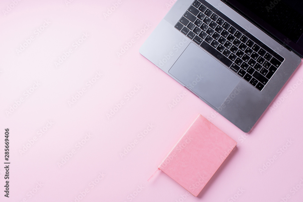 Flatlay with laptop and notebook on pink background. Top view, copy space. Workplace concept. Flatlay with laptop and notebook on pink background. Top view, copy space. Workplace concept.