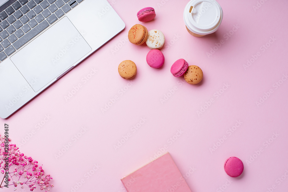 Flatlay with laptop, coffee and macarons on pink background. Top view, copy space. Workplace concept. Flatlay with laptop, coffee and macarons on pink background. Top view, copy space. Workplace concept.