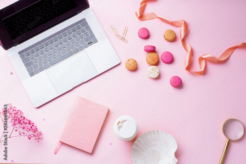 Flatlay with laptop, coffee and macarons on pink background. Top view, copy space. Workplace concept. Flatlay with laptop, coffee and macarons on pink background. Top view, copy space. Workplace concept.