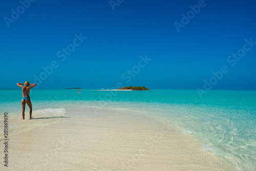 Woman looks at distant island in the Maldives