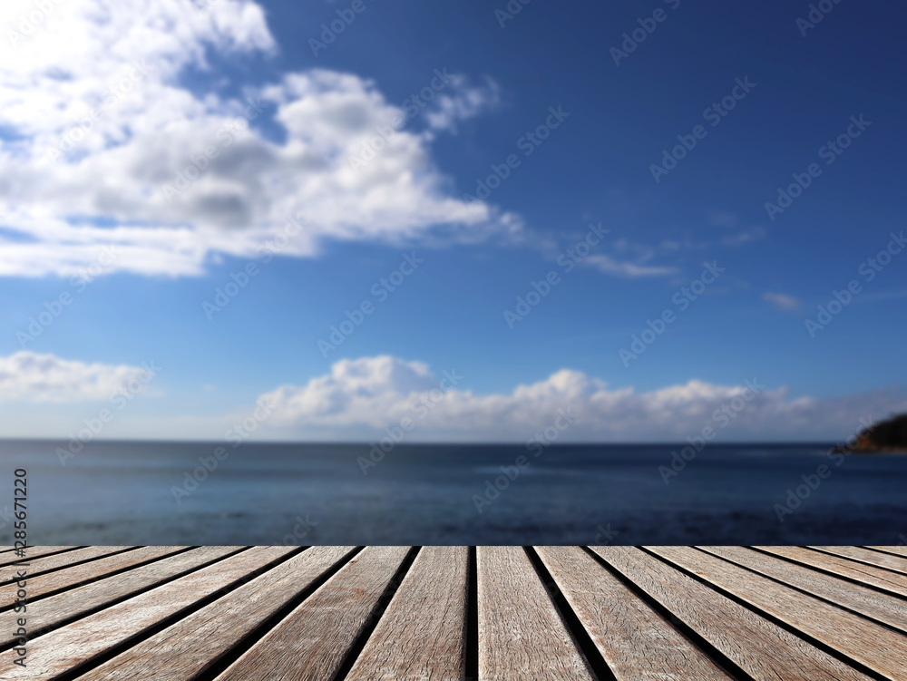 wooden table top empty for display product and blurred sea background.