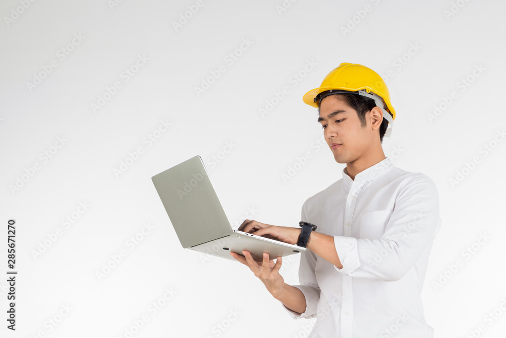 Portrait of young architects holding a laptop on a white background. concept for the new generation Portrait of young architects holding a laptop on a white background. concept for the new generation