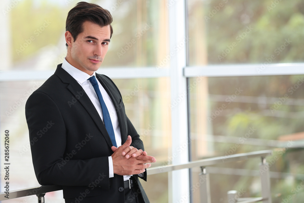 Handsome young man in stylish suit indoors. Space for text Handsome young man in stylish suit indoors. Space for text