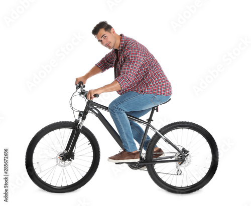 Handsome young man with modern bicycle on white background