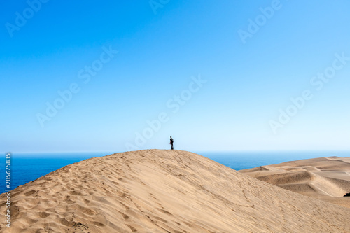 Young male hiker walking at Concon sand dune in Vina del Mar, Chile © nomadkate
