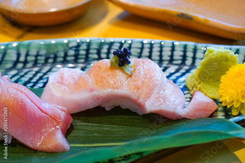 close up fesh sliced raw tuna or Otoro or Fatty Tuna sushi on the dish. Japanese traditional food. Selective focus. photo