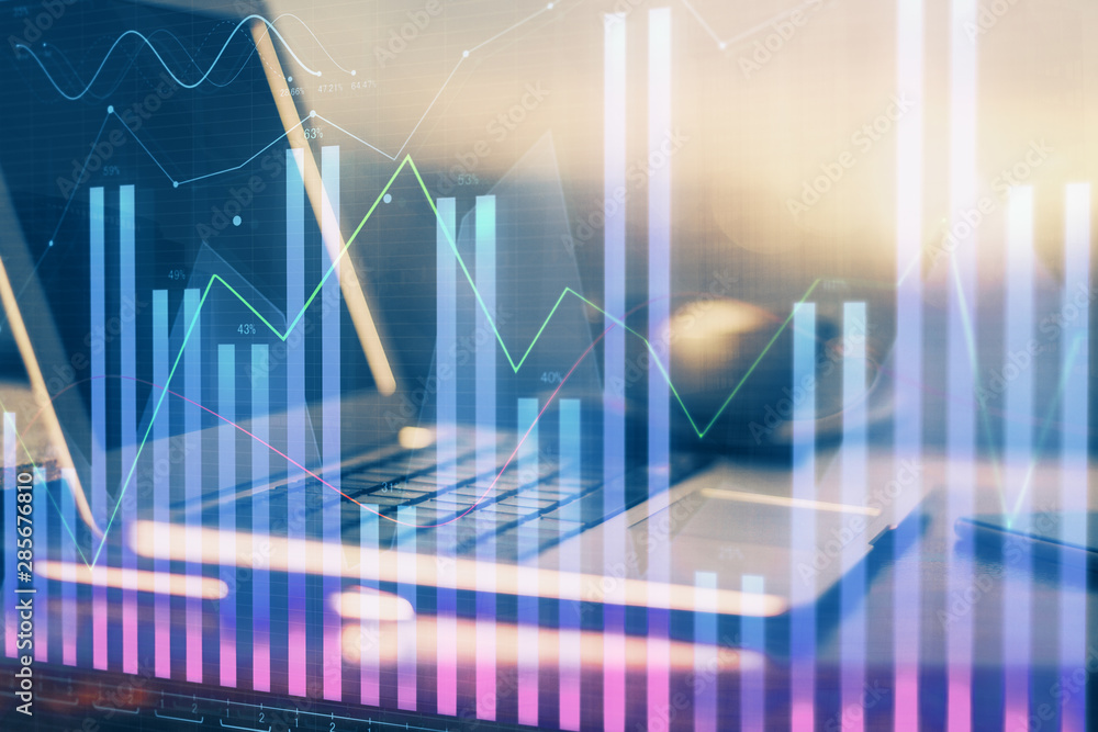 Financial chart drawing and table with computer on background. Multi exposure. Concept of international markets. Financial chart drawing and table with computer on background. Multi exposure. Concept of international markets.