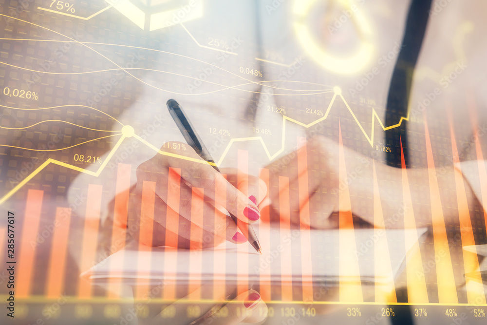 Double exposure of hands making notes with forex chart huds. Stock market concept. Double exposure of hands making notes with forex chart huds. Stock market concept.