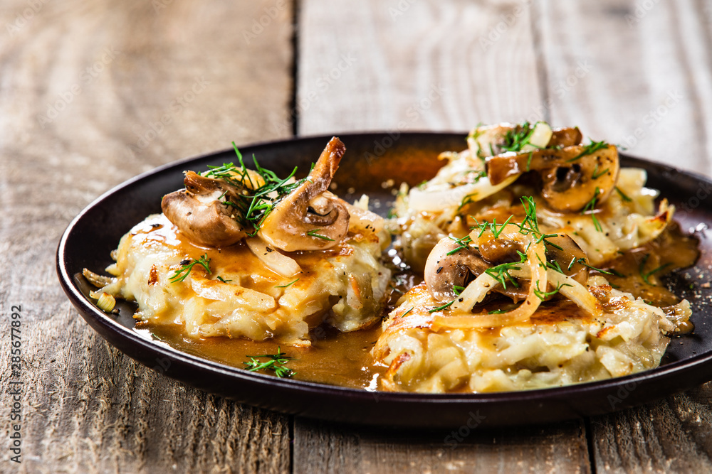 Potato cakes with gravy sauce and champignon Potato cakes with gravy sauce and champignon