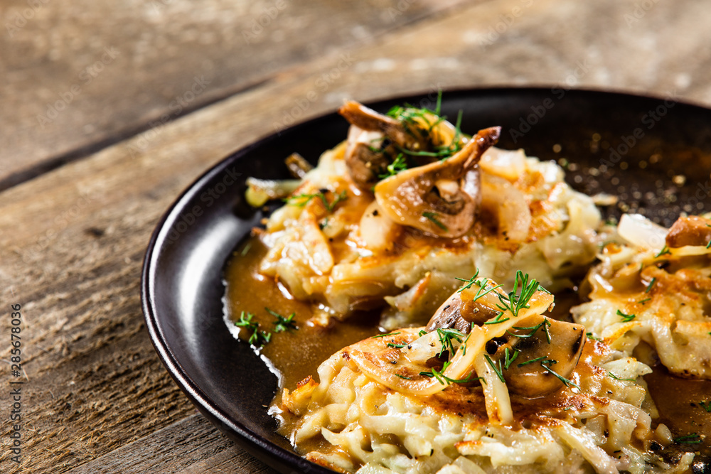 Potato cakes with gravy sauce and champignon Potato cakes with gravy sauce and champignon