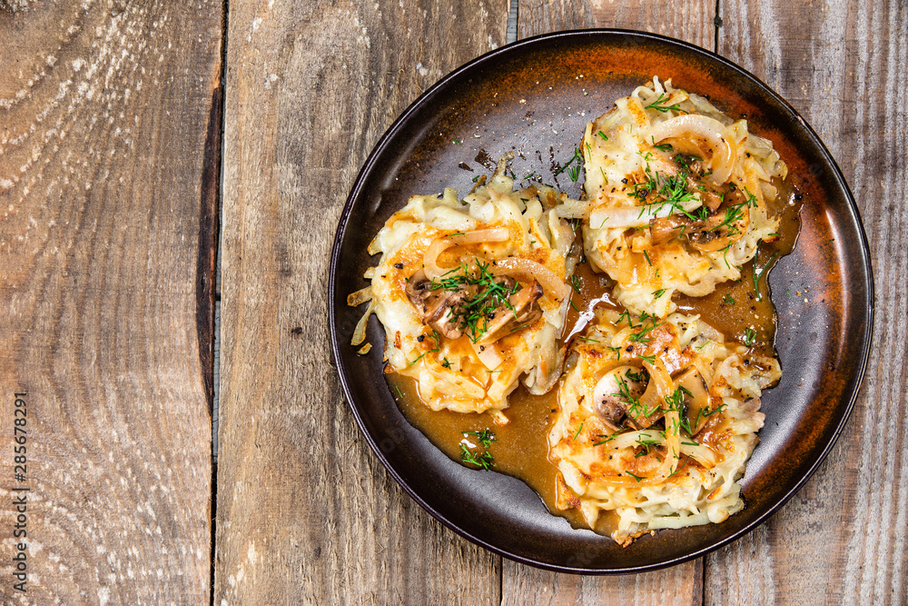 Potato cakes with gravy sauce and champignon Potato cakes with gravy sauce and champignon