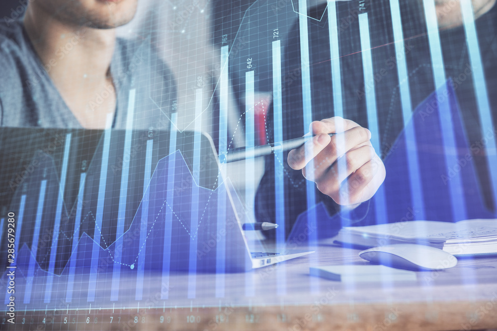 Forex graph with businessman typing on computer in office on background. Concept of analysis. Double exposure. Forex graph with businessman typing on computer in office on background. Concept of analysis. Double exposure.