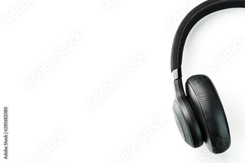 Wireless black headphones on white, isolate. On-ear headphones for playing games and listening to music tracks. Close-up