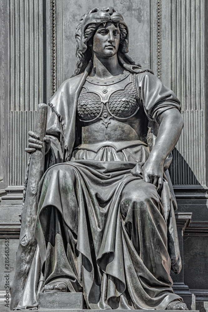 Old statue of a sensual woman warrior as defender with lion head and club at the Neumarkt in downtown of Dresden, Germany, details, closeup