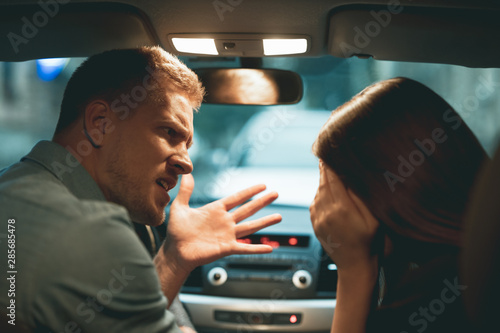 young couple man and woman having argument sitting in the car