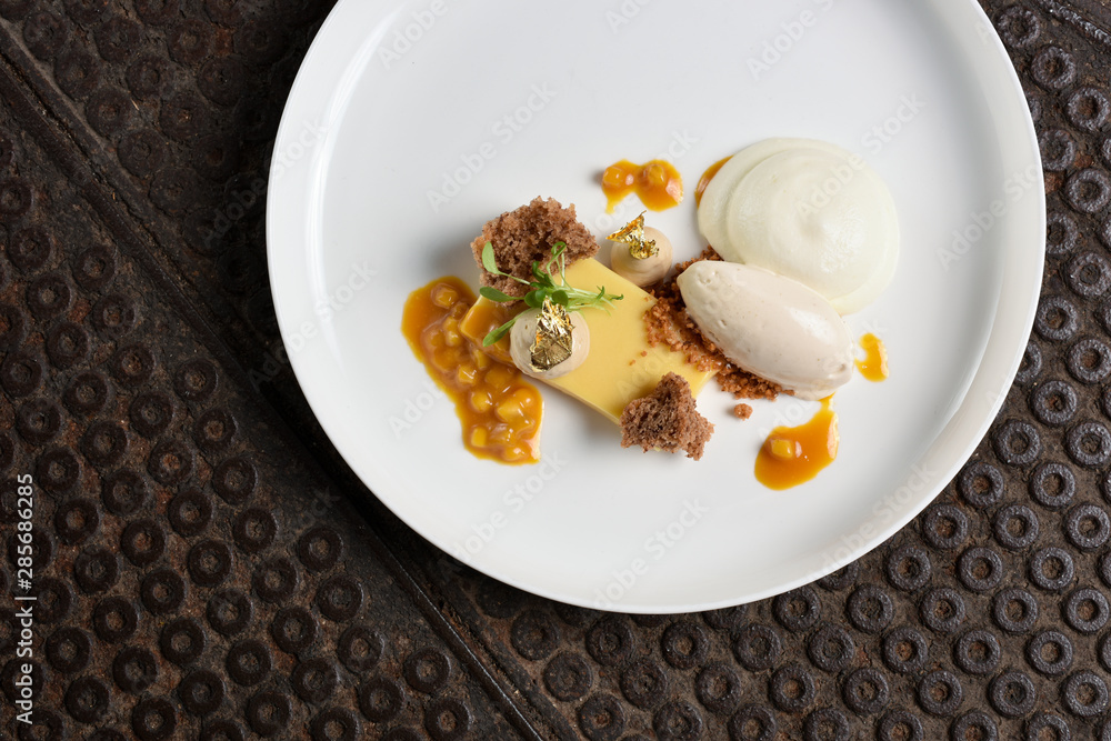 Fine dining dessert, Carrot cake,caramel ice cream, white chocolate mousse and spices Fine dining dessert, Carrot cake,caramel ice cream, white chocolate mousse and spices