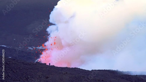 Mount Etna Eruption - Lava flow and ash emission in volcano Etna in Sicily photo