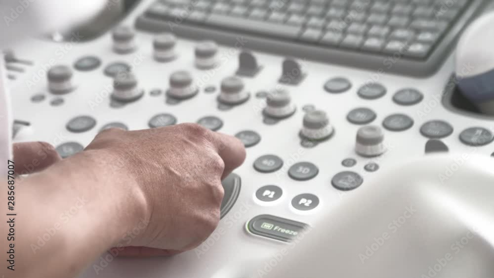 Ultrasound Console Is Getting Operated by Doctor's Hands. Orbiting camera Ultrasound Console Is Getting Operated by Doctor's Hands. Orbiting camera