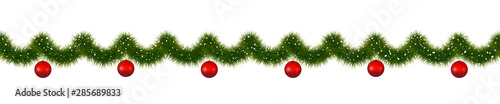 Christmas garland with red balls. New year decorations covered with snow.